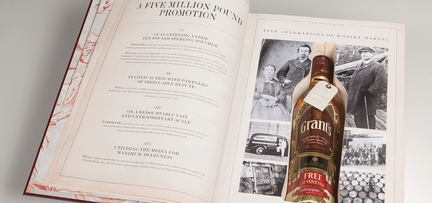 Large leather bound book containing a bottle of Grant’s Whisky set into the book