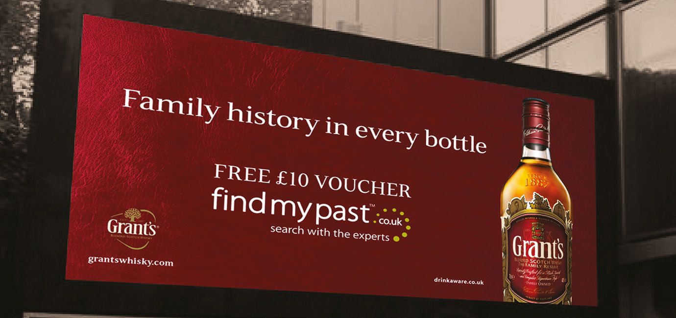 Roadside poster showing the Grant’s Whisky bottle and campaign to win £10 of family history in every bottle
